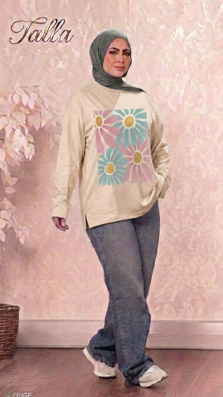 Talla | طلةّ beige long sleeve sweatshirt with floral graphic print worn by a woman in a hijab and grey trousers