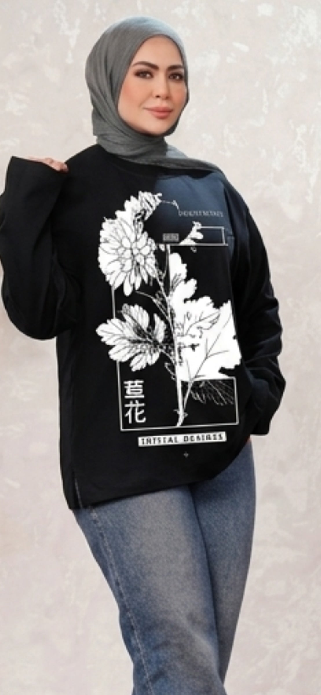 Talla | طلةّ black long sleeve sweatshirt with white floral line-art graphic print and side-slit hem worn by a model