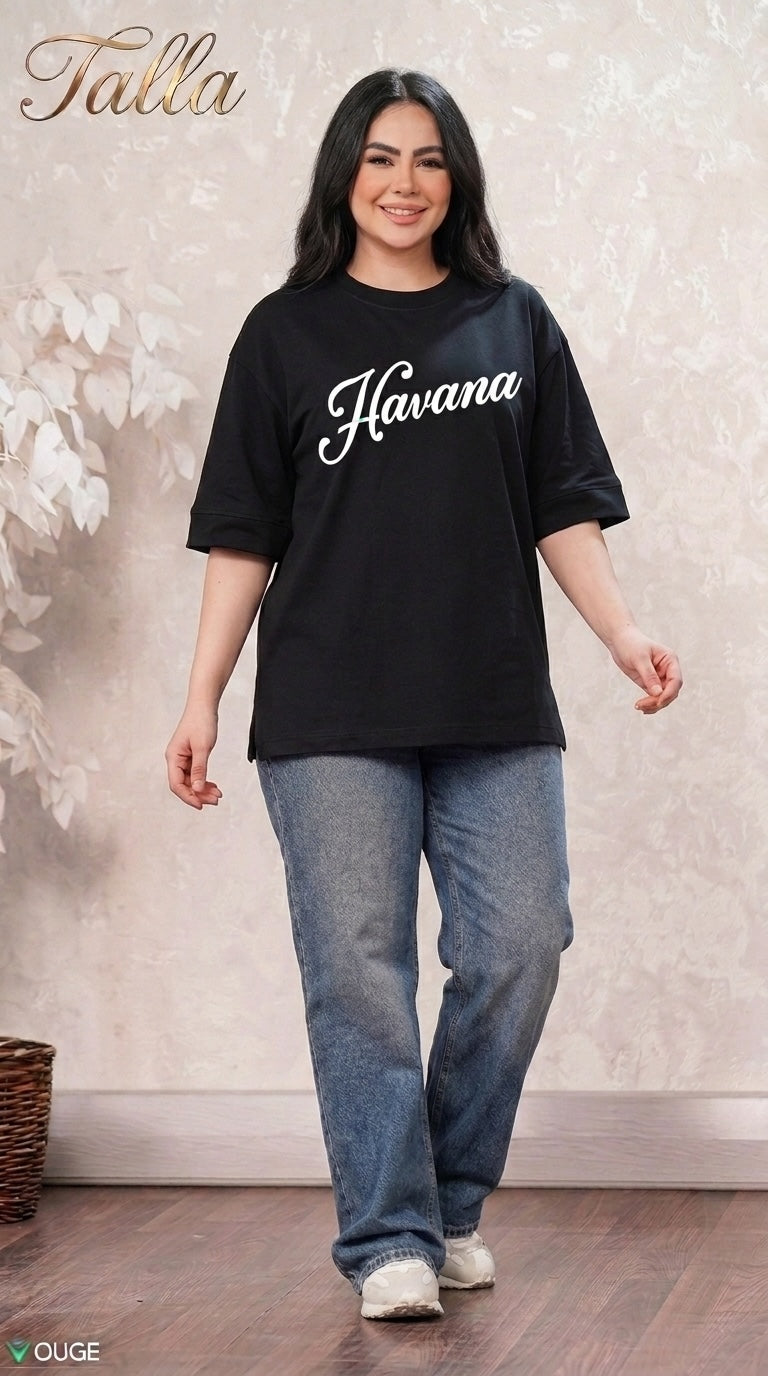 Talla | طلةّ black oversized Havana graphic t-shirt with elbow-length sleeves worn by a smiling woman with blue jeans