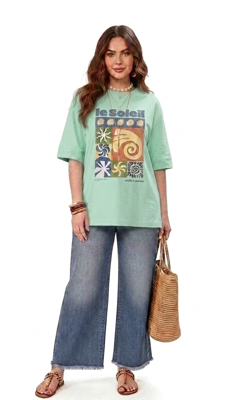 Talla | طلةّ oversized mint green cotton t-shirt with retro sun graphic print worn with wide-leg denim jeans