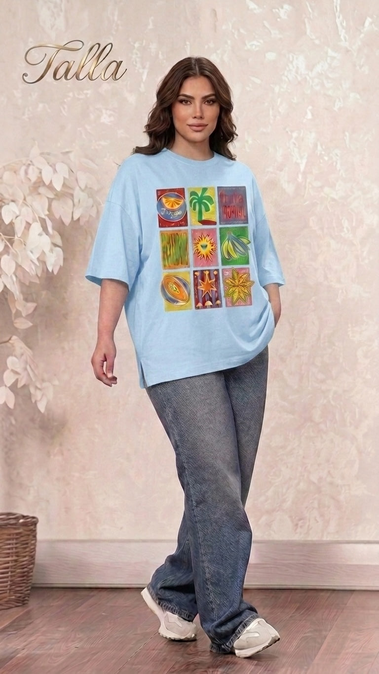 Talla | طلةّ light blue oversized t-shirt with a multi-panel tropical graphic print worn by a woman with jeans.