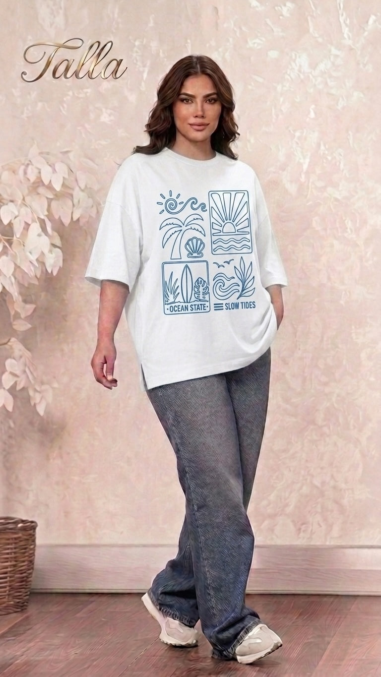 Model wearing a Talla | طلةّ white oversized cotton t-shirt with a blue coastal graphic print and dropped shoulders.