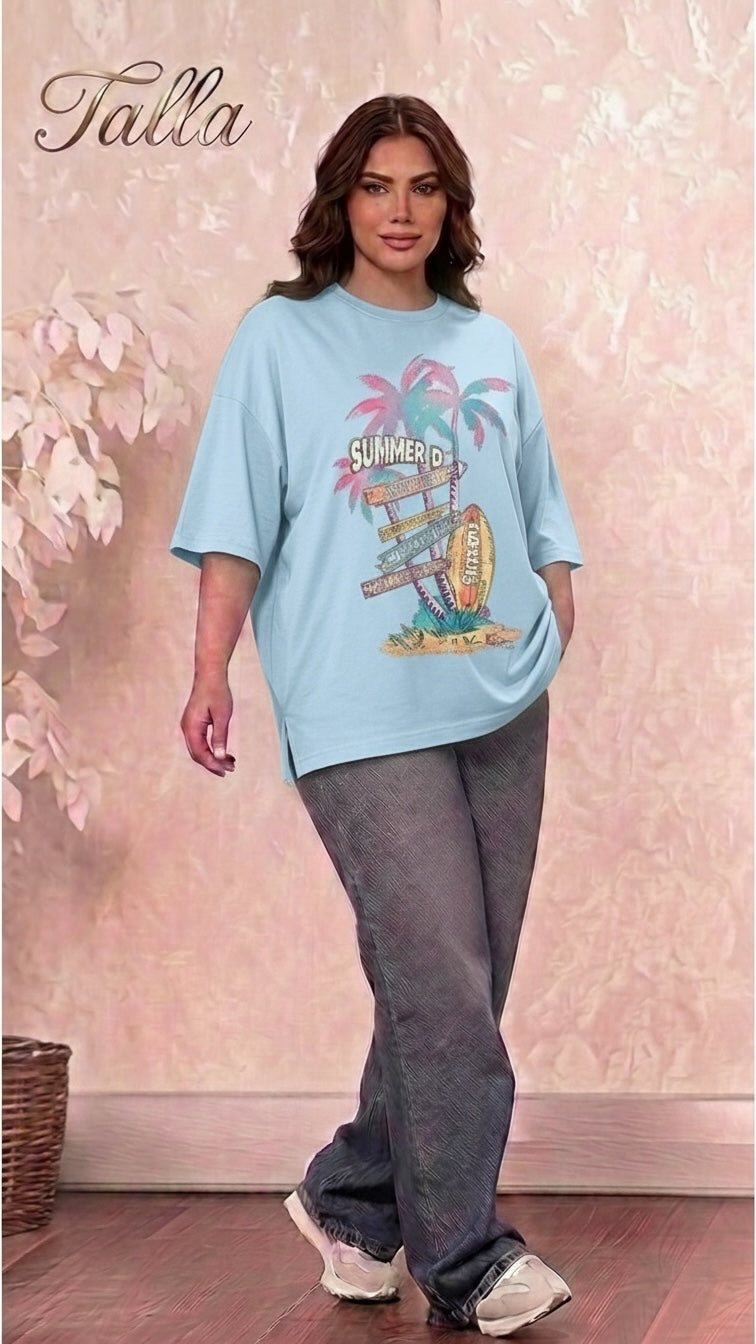 Talla | طلةّ light blue oversized graphic t-shirt with summer beach print and side slits worn by a woman