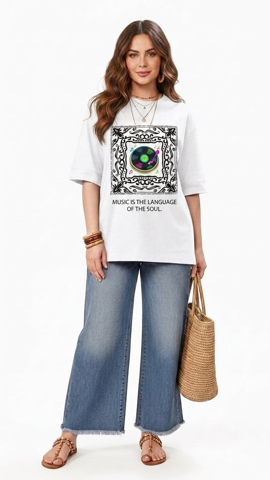 Talla | طلةّ white oversized graphic t-shirt with record player print and music slogan worn with wide-leg jeans