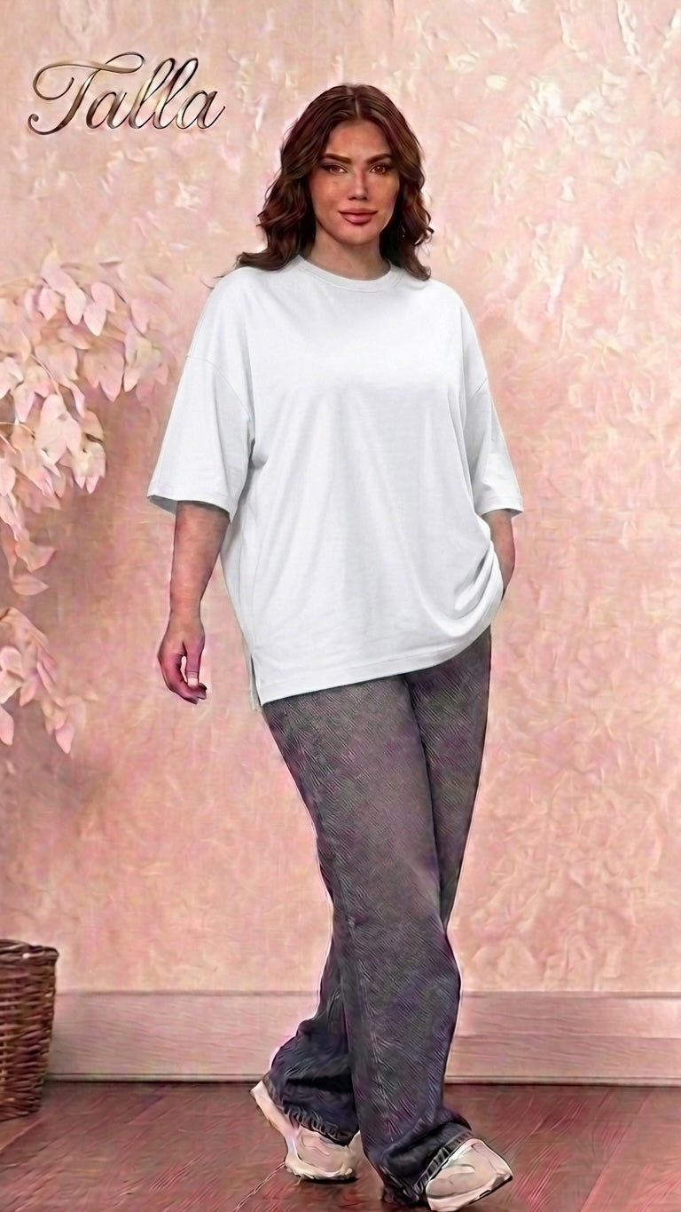 Model wearing a Talla | طلةّ white oversized cotton crewneck t-shirt with dropped shoulders and side-slit hem.