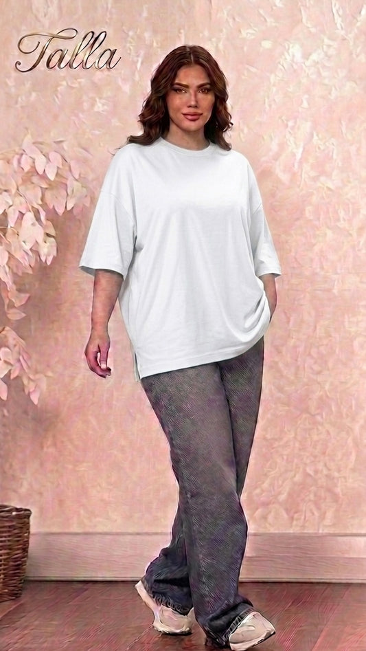 Model wearing a Talla | طلةّ white oversized cotton crewneck t-shirt with dropped shoulders and side-slit hem.