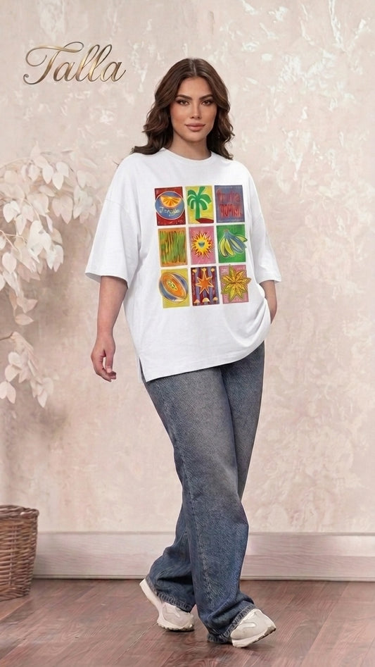 Talla | طلةّ white oversized t-shirt with a colorful tropical multi-panel graphic print worn by a woman with jeans.