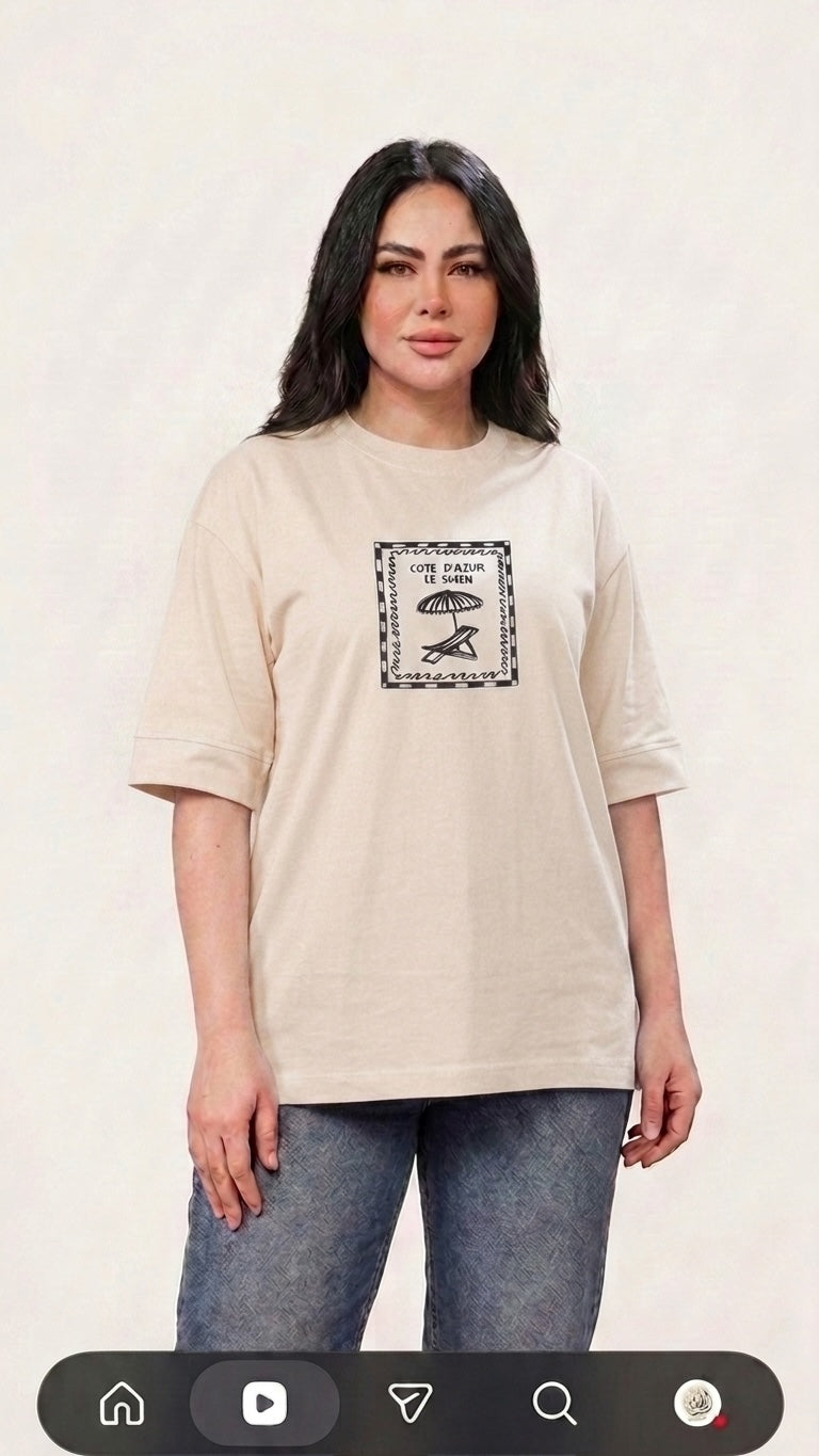 Talla | طلةّ beige oversized cotton t-shirt with a vintage Cote d'Azur graphic print and drop-shoulder design.
