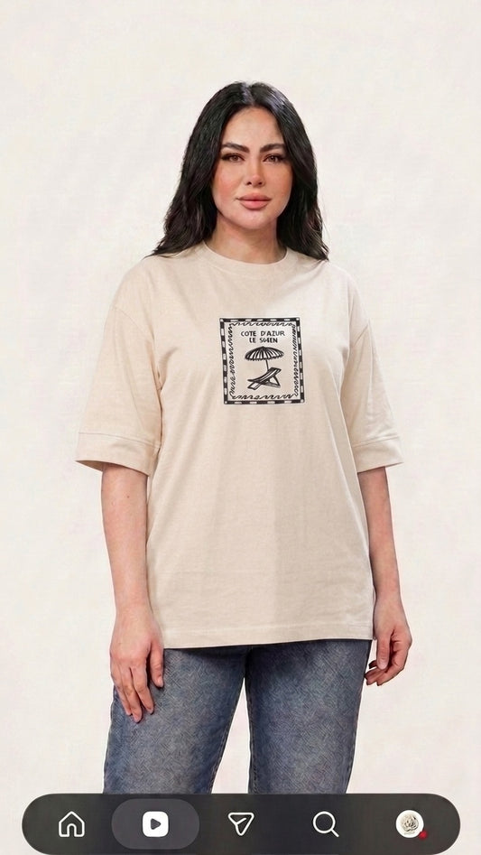 Talla | طلةّ beige oversized cotton t-shirt with a vintage Cote d'Azur graphic print and drop-shoulder design.