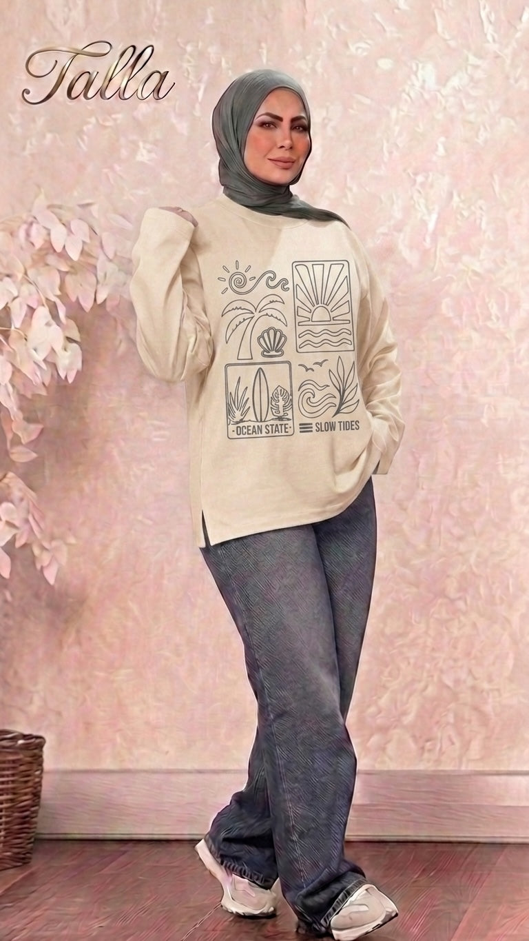 Talla | طلةّ beige long sleeve sweatshirt with Ocean State graphic print, worn by a woman in a hijab and jeans.
