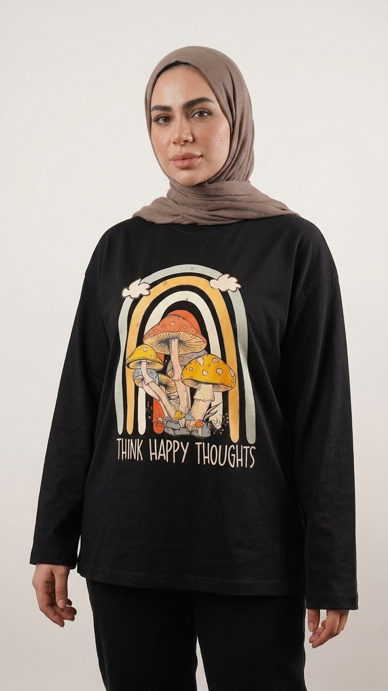 Talla | طلةّ black long-sleeve cotton t-shirt with a retro mushroom and rainbow graphic print worn by a model.
