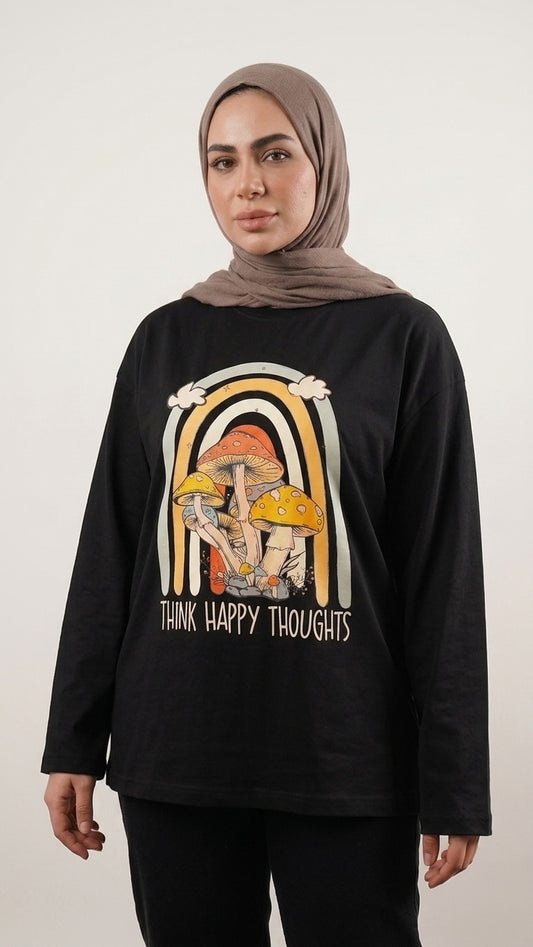 Talla | طلةّ black long-sleeve cotton t-shirt with a retro mushroom and rainbow graphic print worn by a model.