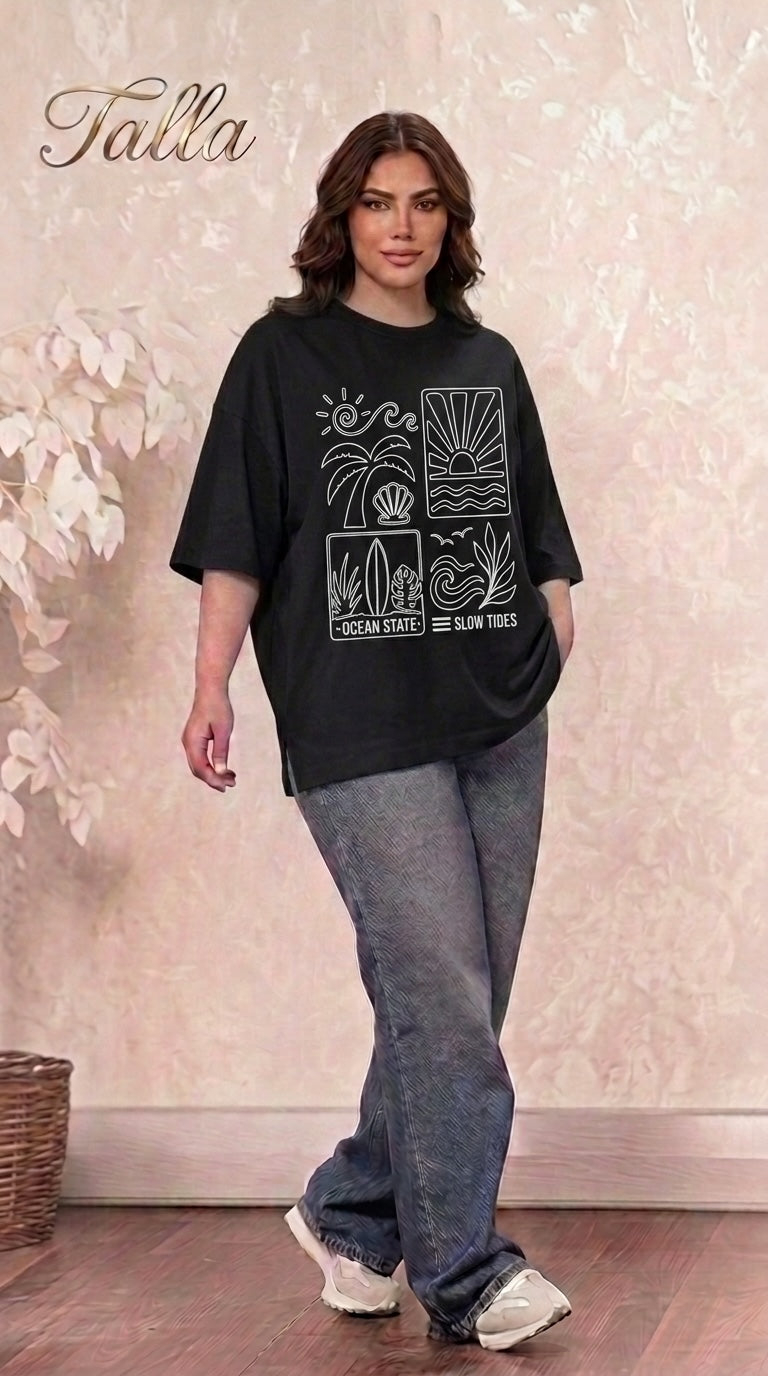 Talla | طلةّ black oversized cotton t-shirt with white ocean-themed graphic print worn by a woman with jeans