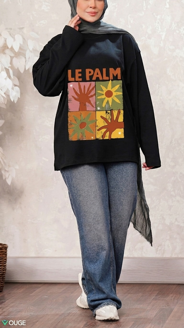 Talla | طلةّ black long sleeve sweatshirt with Le Palm graphic print, worn by a model in blue jeans and a hijab.