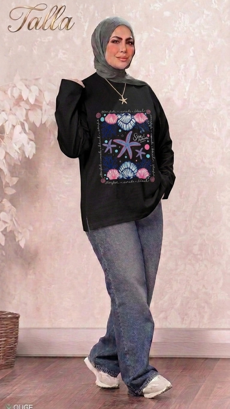 Talla | طلةّ black long sleeve sweatshirt with nautical starfish and seashell graphic print worn with jeans and hijab