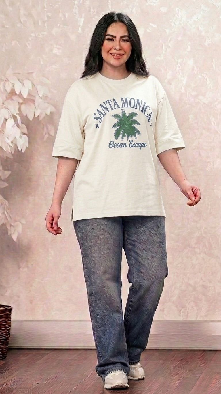 Talla | طلةّ oversized cream cotton t-shirt with Santa Monica palm tree graphic, crew neck, and side-slit hem.