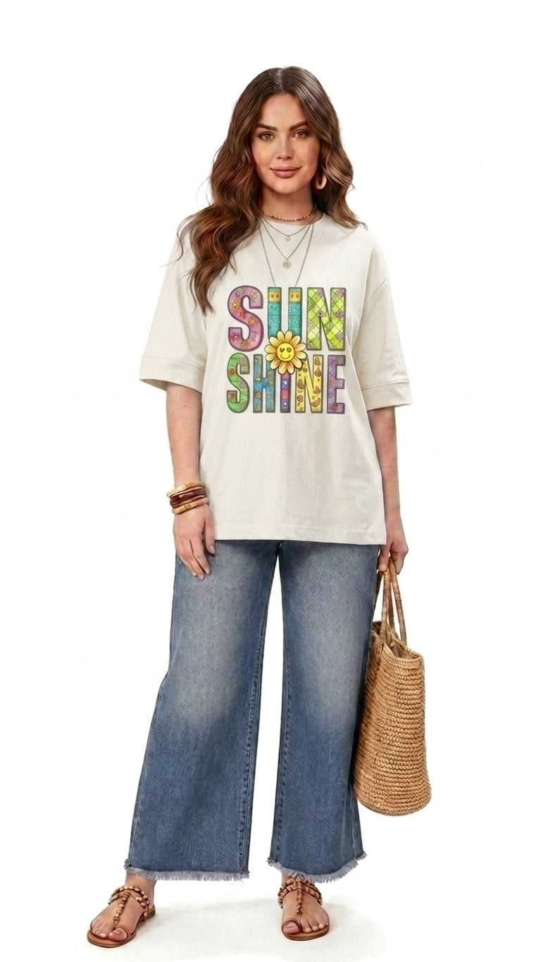 Talla | طلةّ relaxed-fit cream t-shirt with a colorful SUNSHINE graphic and sunflower print worn with wide-leg jeans