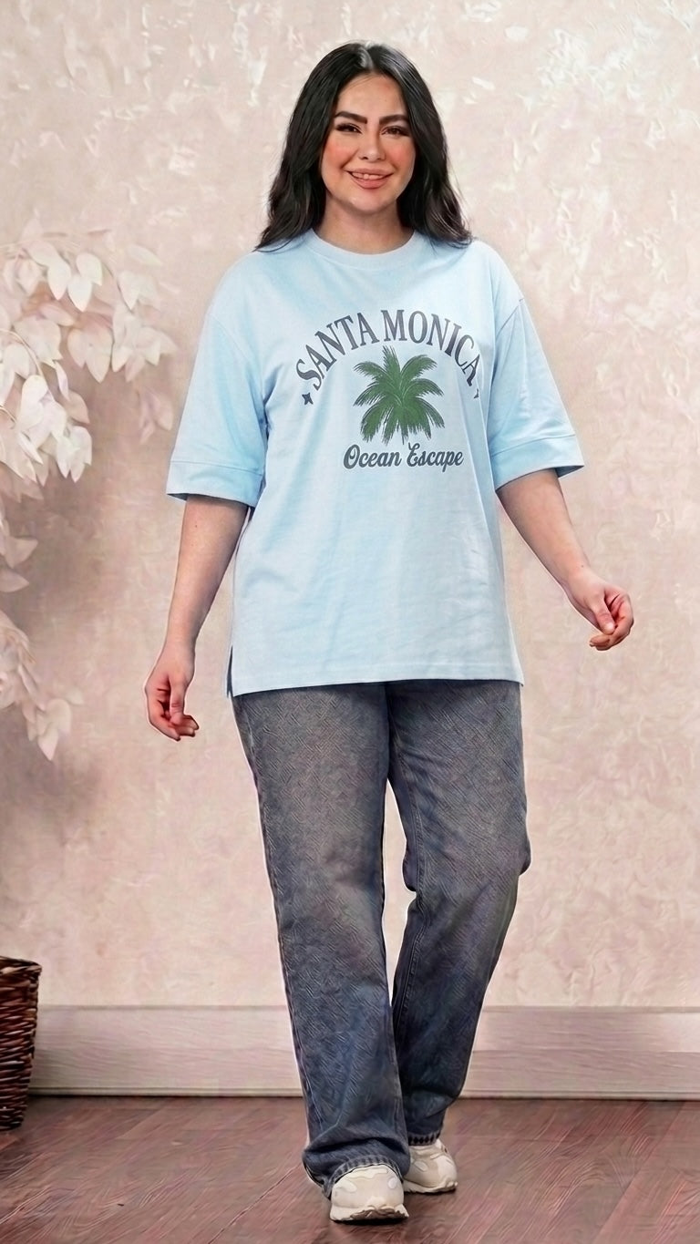 Talla | طلةّ light blue oversized cotton t-shirt with Santa Monica palm tree graphic, crew neck, and side-slit hem.