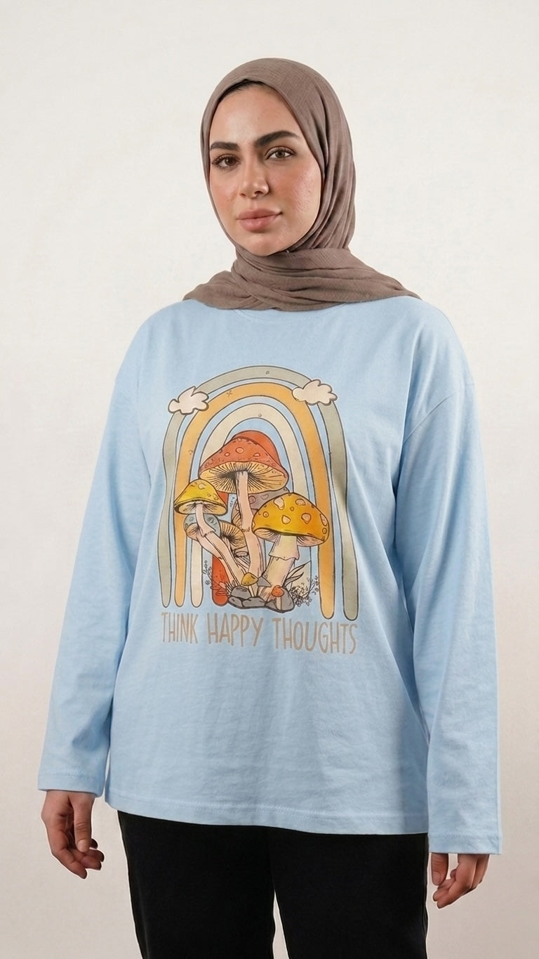 Talla | طلةّ light blue long-sleeve cotton tee featuring a retro mushroom and rainbow Think Happy Thoughts graphic