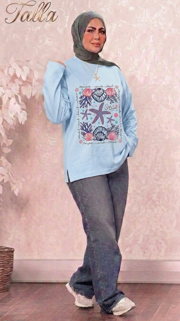 Talla | طلةّ light blue long sleeve sweatshirt with nautical starfish and seashell graphic print and side slits.