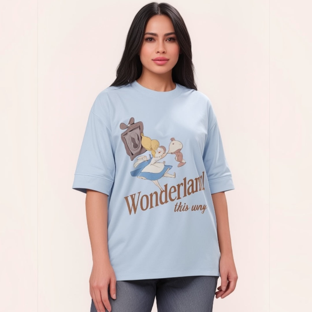 Talla | طلةّ light blue oversized cotton t-shirt with a whimsical Wonderland graphic print and elbow-length sleeves.