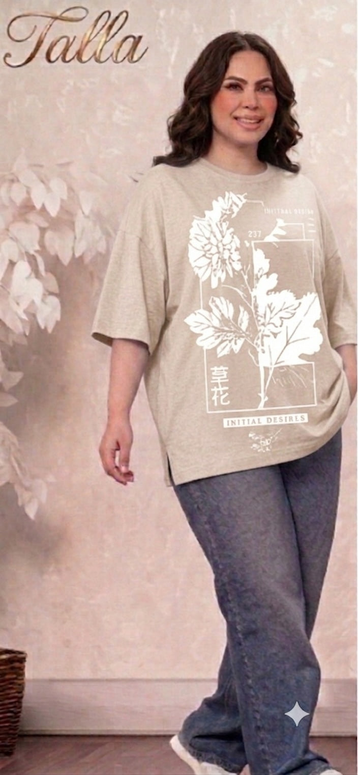 Talla | طلةّ oversized beige t-shirt with white floral graphic print, crew neck, and side-slit hem worn by a woman.