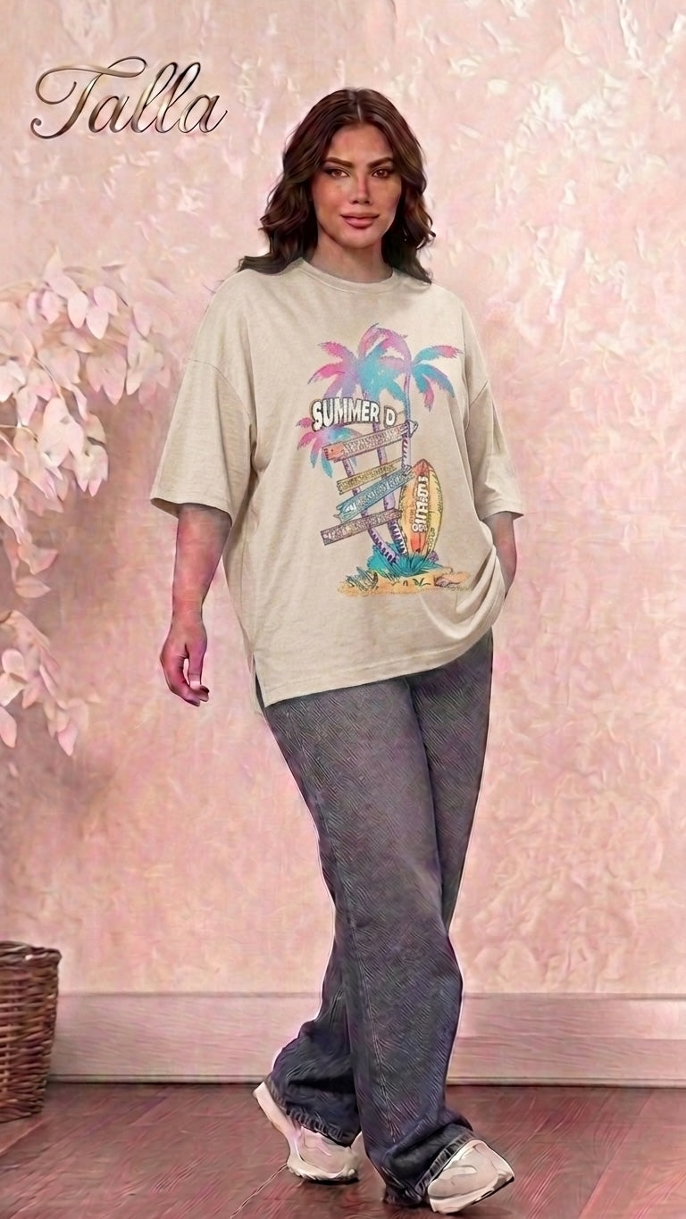 Talla | طلةّ oversized beige graphic t-shirt with summer print, worn by a woman with dark wavy hair and grey jeans.