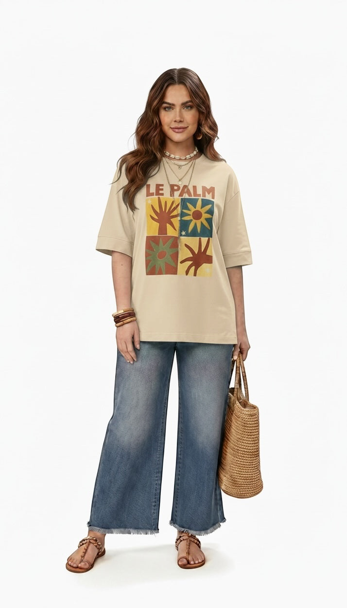 Talla | طلةّ oversized beige cotton t-shirt with a multi-paneled sun graphic print worn by a woman with denim jeans.