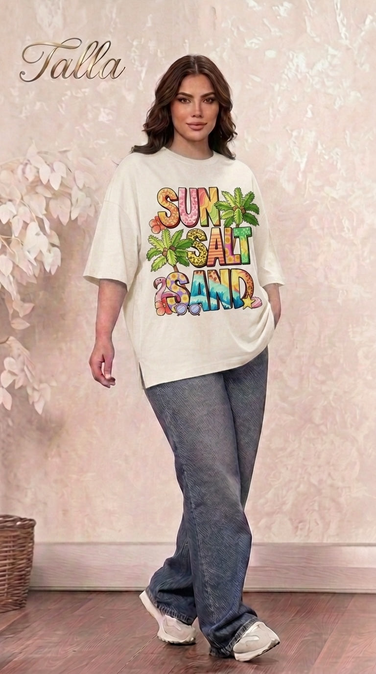 Talla | طلةّ oversized cream t-shirt with Sun Salt Sand tropical graphic print worn by a woman with jeans