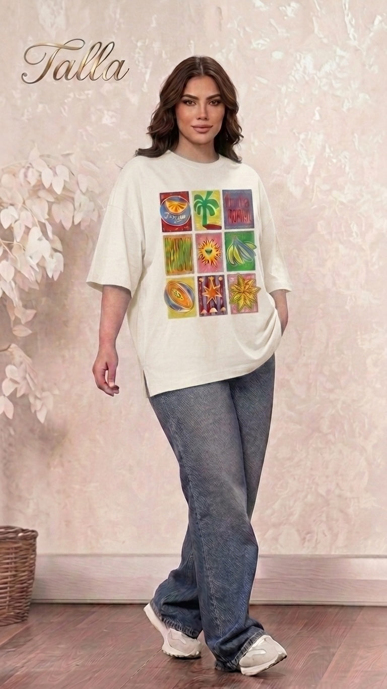 Talla | طلةّ oversized cream t-shirt with a colorful tropical graphic print, styled with loose denim jeans.