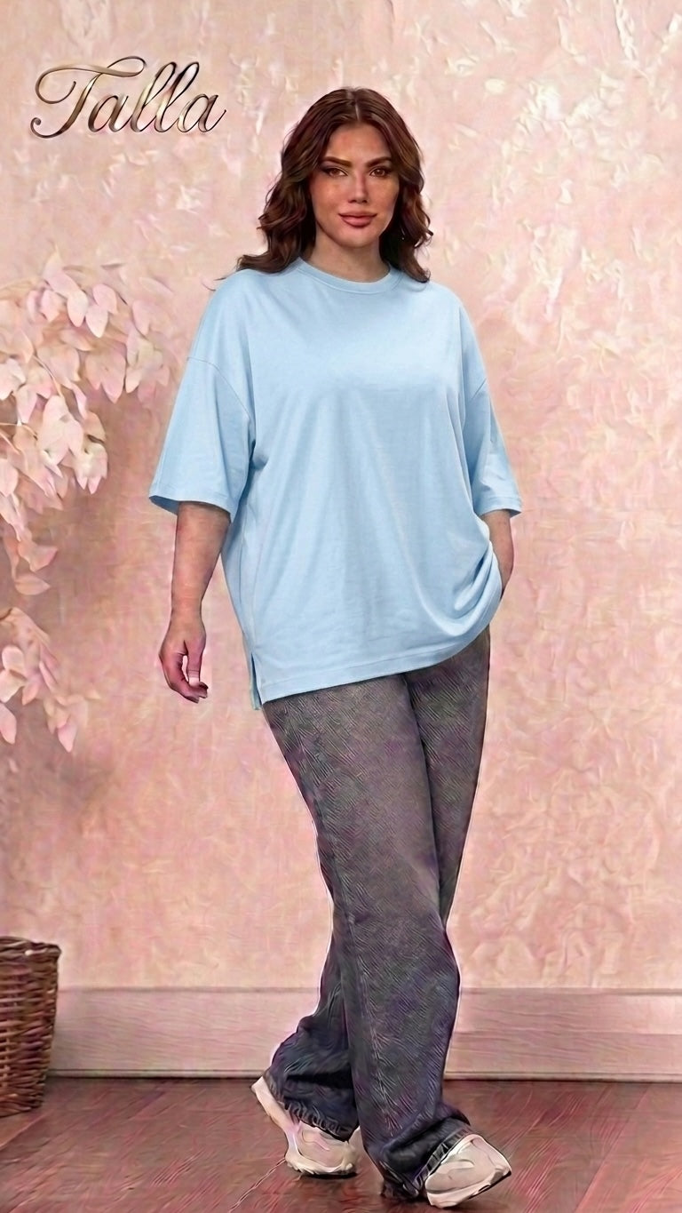 Talla | طلةّ oversized light blue cotton crewneck t-shirt with dropped shoulders and side slits worn by a woman