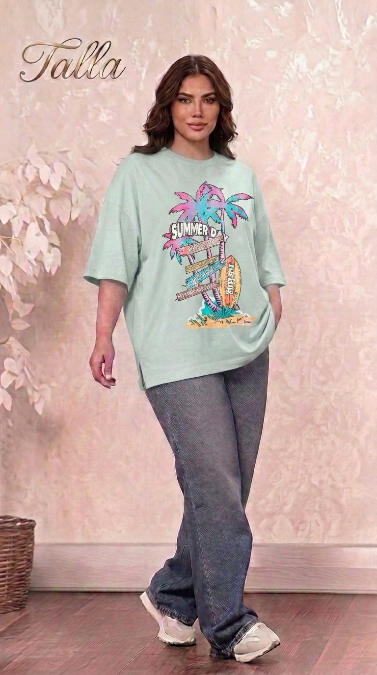 Talla | طلةّ oversized mint green graphic t-shirt with summer palm tree print and side slits worn by a woman