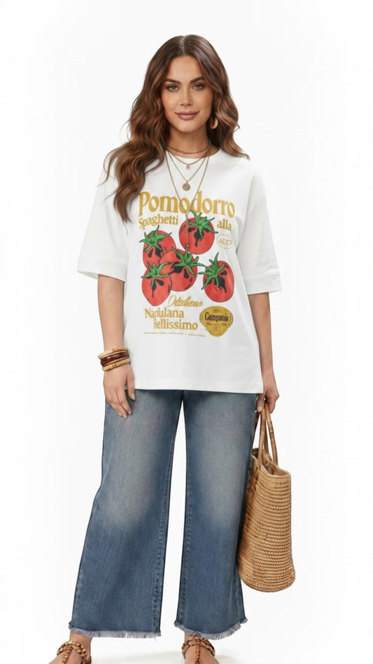 Talla | طلةّ oversized white cotton t-shirt featuring a vintage-style red tomato graphic print on a model