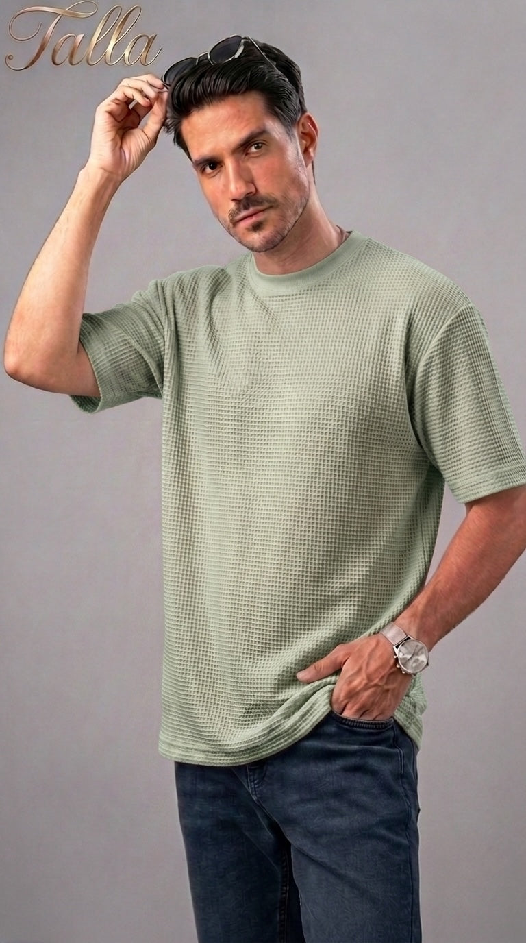 Talla | طلةّ men's sage green waffle-knit crew neck t-shirt with short sleeves worn by a model with sunglasses.