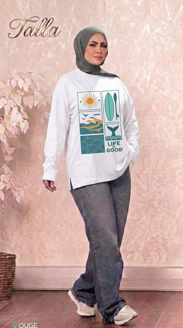 Talla | طلةّ white long sleeve sweatshirt with Life is Good graphic print worn by a woman in a grey hijab and jeans