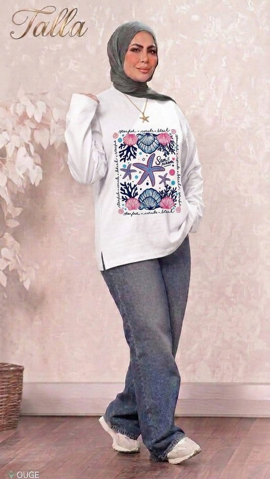 Talla | طلةّ white long sleeve sweatshirt with nautical starfish and seashell graphic print worn with jeans and hijab
