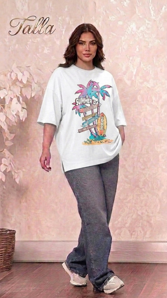 A model wearing a Talla | طلةّ white oversized graphic t-shirt with a retro summer beach print and side-slit hem.