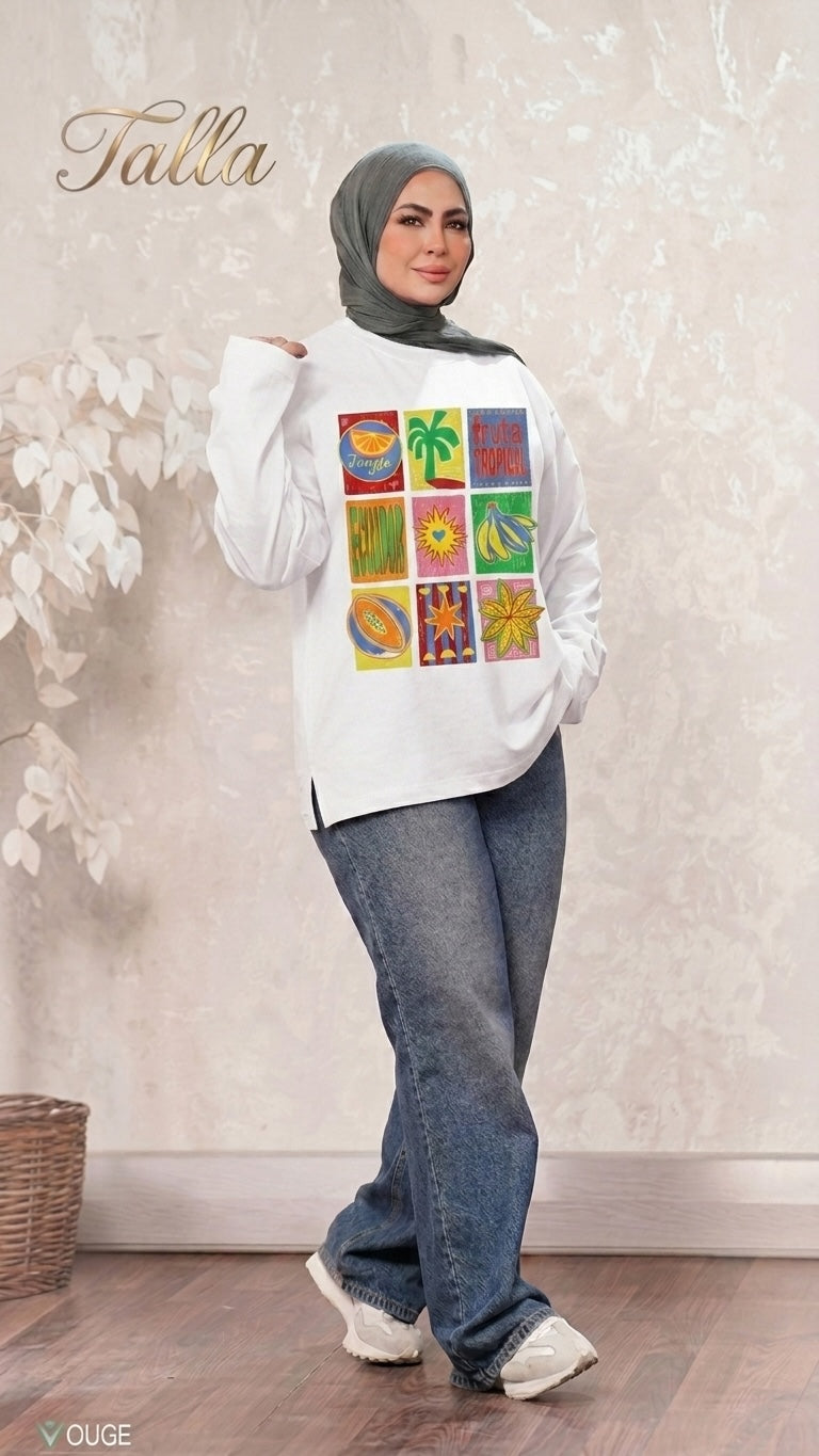Talla | طلةّ white long sleeve sweatshirt with a colorful tropical fruit grid print, worn by a woman in a hijab and jeans.