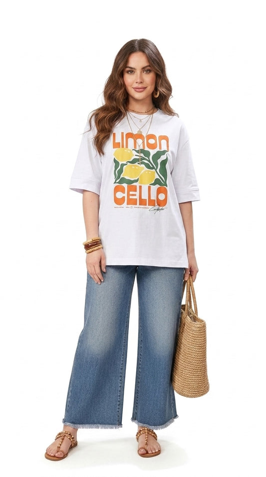 Model wearing a Talla | طلةّ white oversized cotton t-shirt with a Limoncello graphic print and elbow-length sleeves.